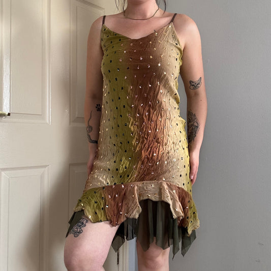 a person wearing a green flowy mesh fairy strappy mini dress.