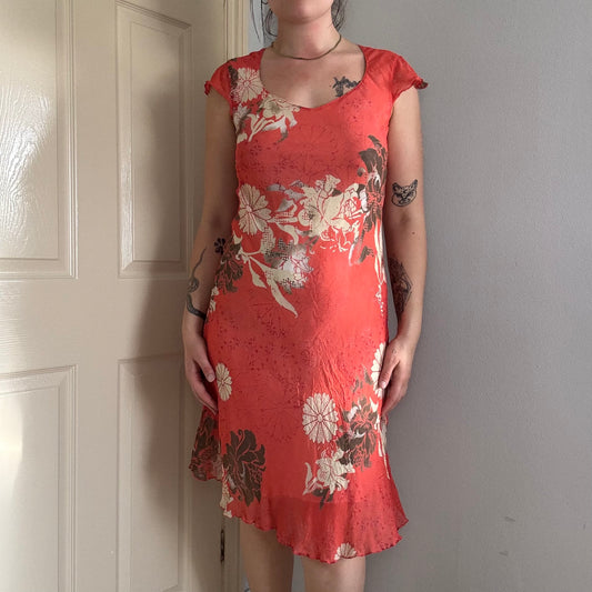 Person wearing a vintage red floral summer dress .