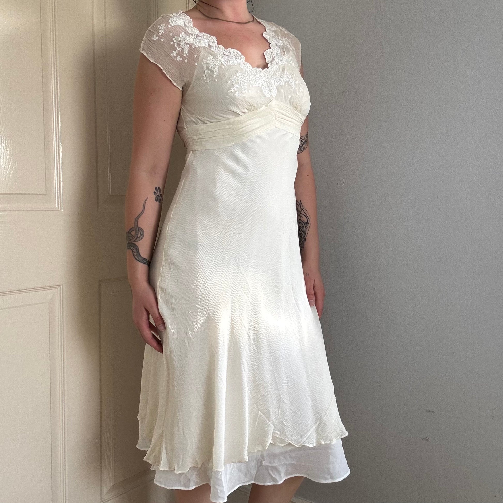 Person wearing a silk mesh embroidered dress.