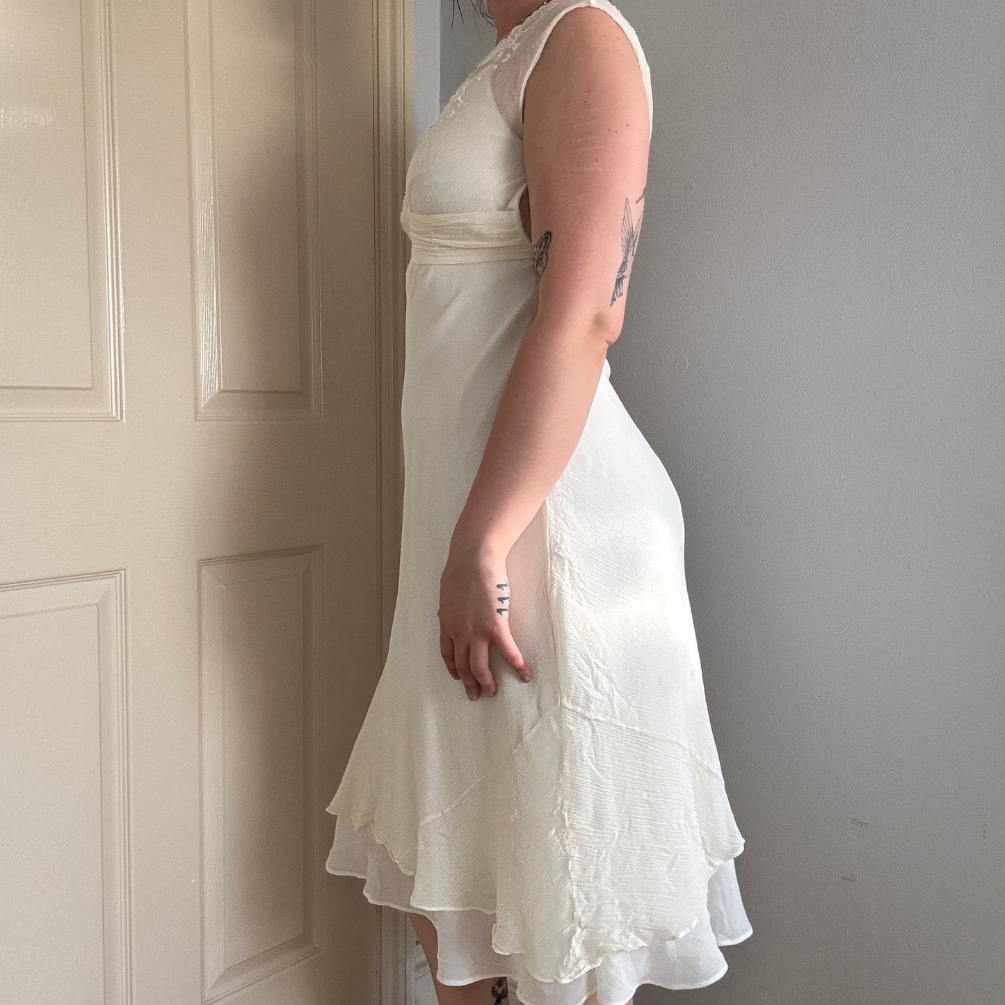 Person wearing a silk mesh embroidered dress.