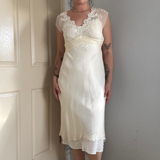 Person wearing a silk mesh embroidered dress.