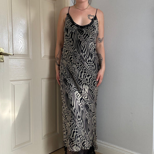 Person wearing a mesh zebra print maxi dress.