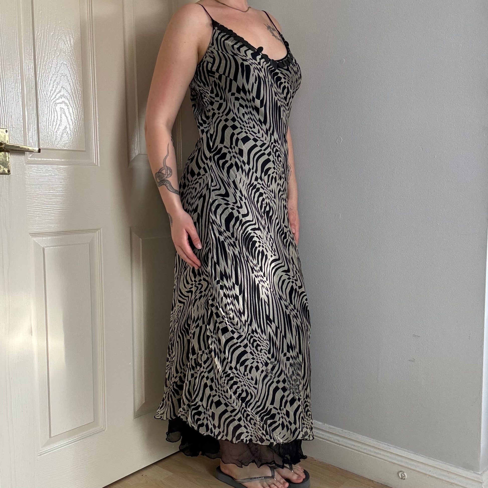 Person wearing a mesh zebra print maxi dress.