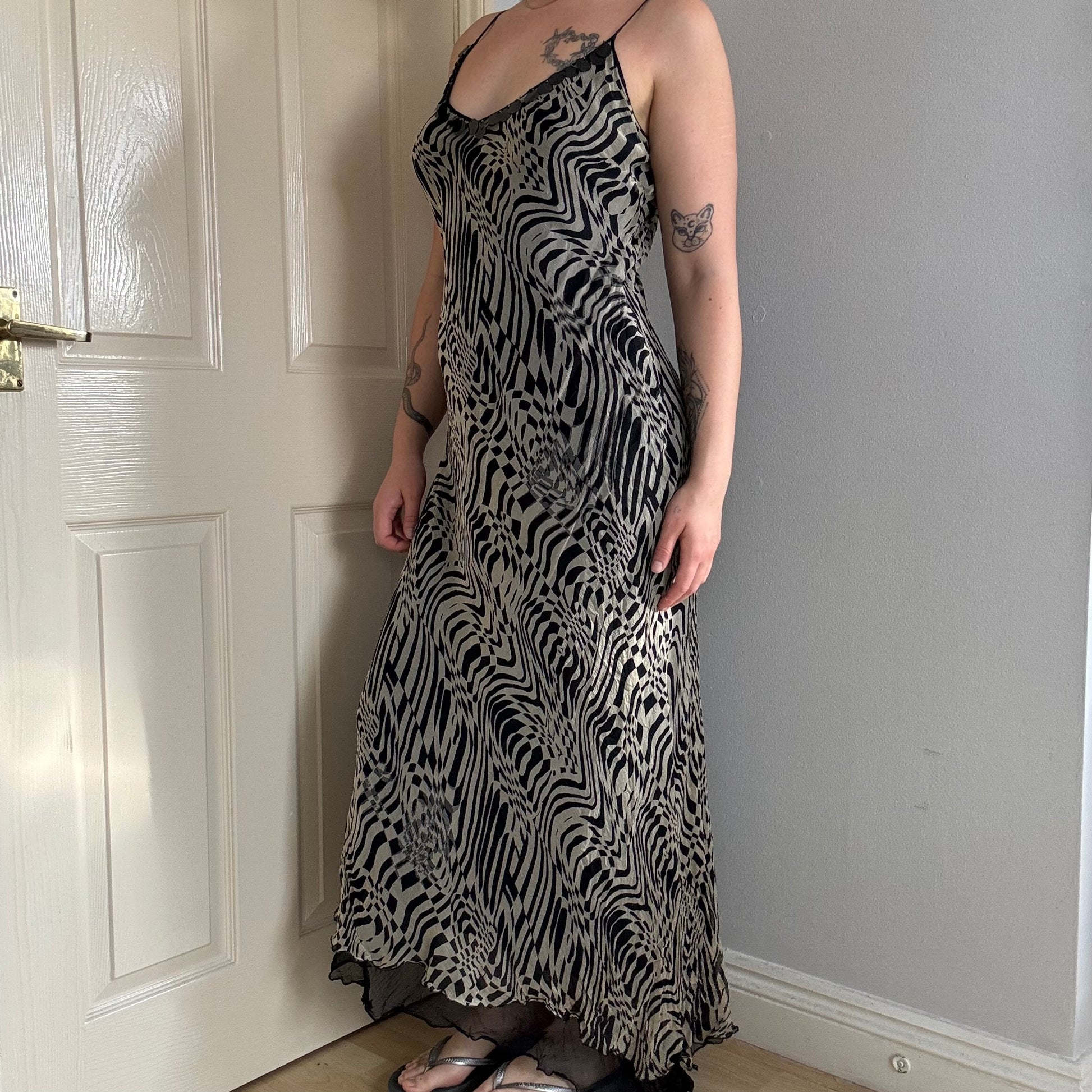 Person wearing a mesh zebra print maxi dress.
